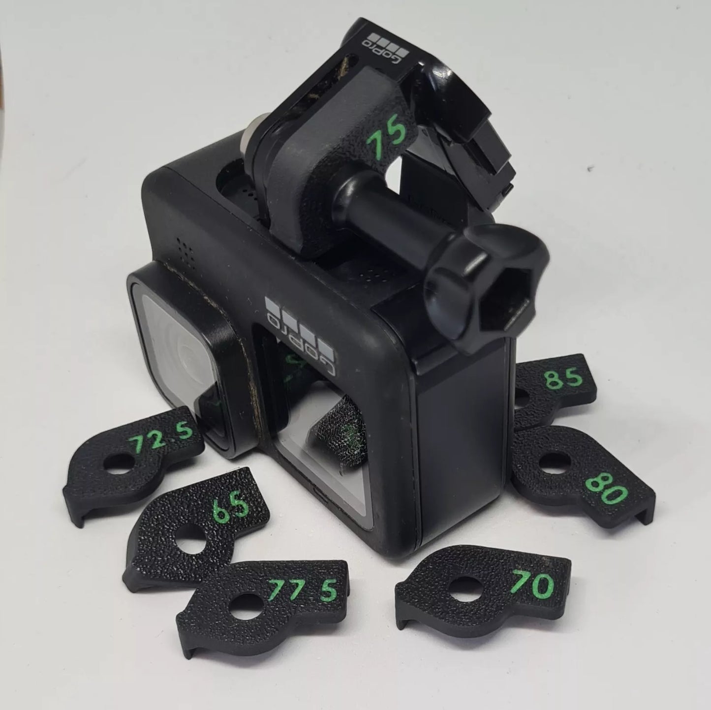 Plastic accessory to set the angle of an aciton camera on a chest mount