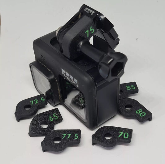 Plastic accessory to set the angle of an aciton camera on a chest mount 